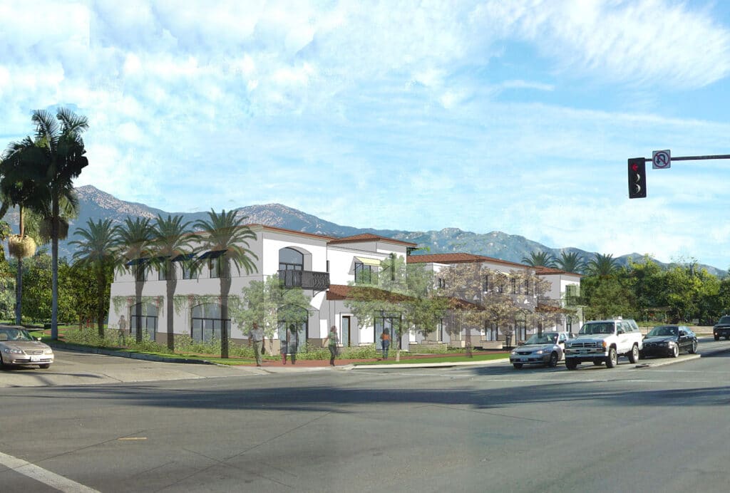 An architectural rendering of a modern two-story apartment complex on a sunny street corner. The white stucco buildings feature red-tiled roofs, arched windows, and dark metal balconies, set against a backdrop of the Santa Barbara mountains with palm trees and parked cars in the foreground.