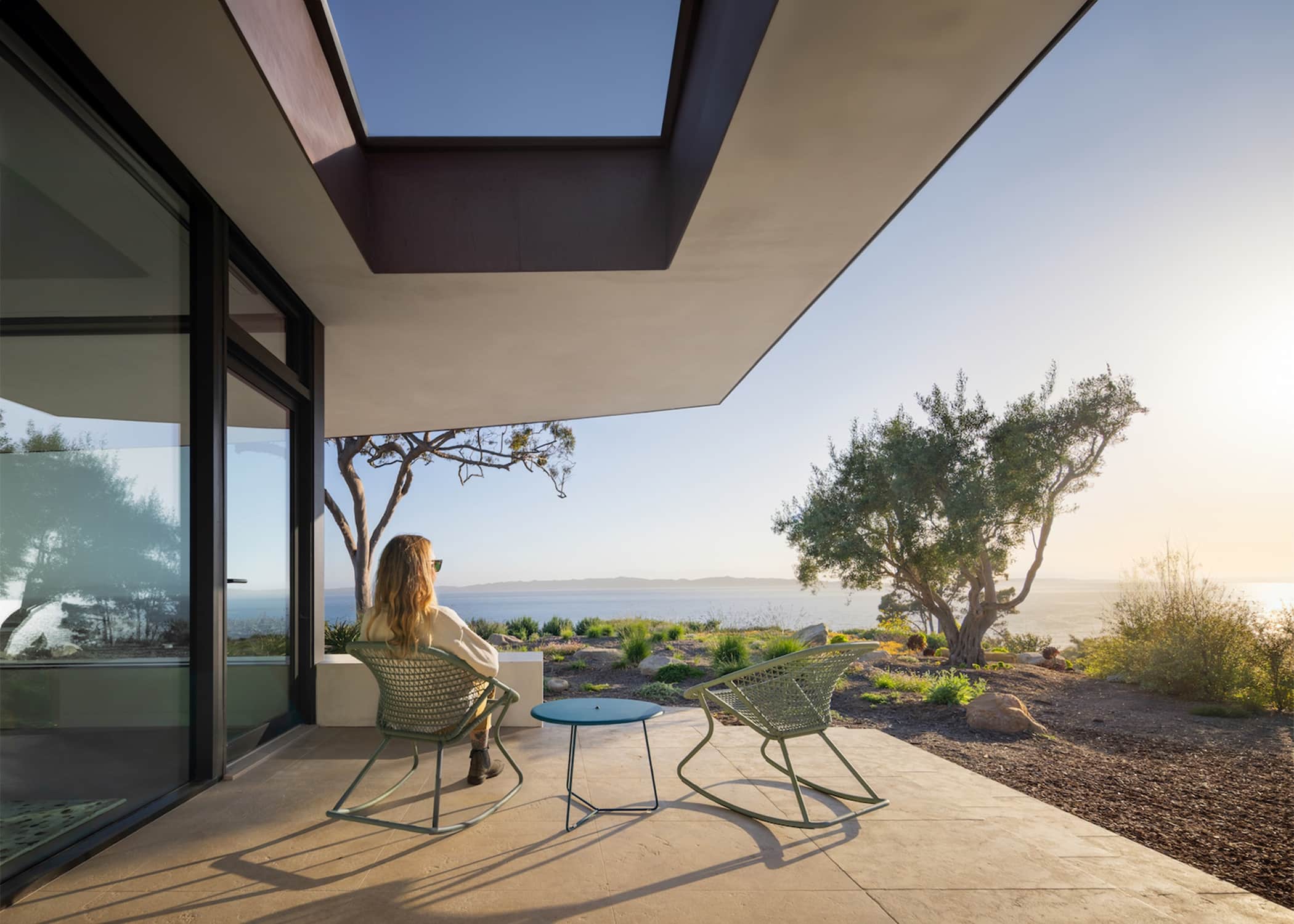 Contemporary coastal residence patio with cantilevered roof and panoramic ocean views